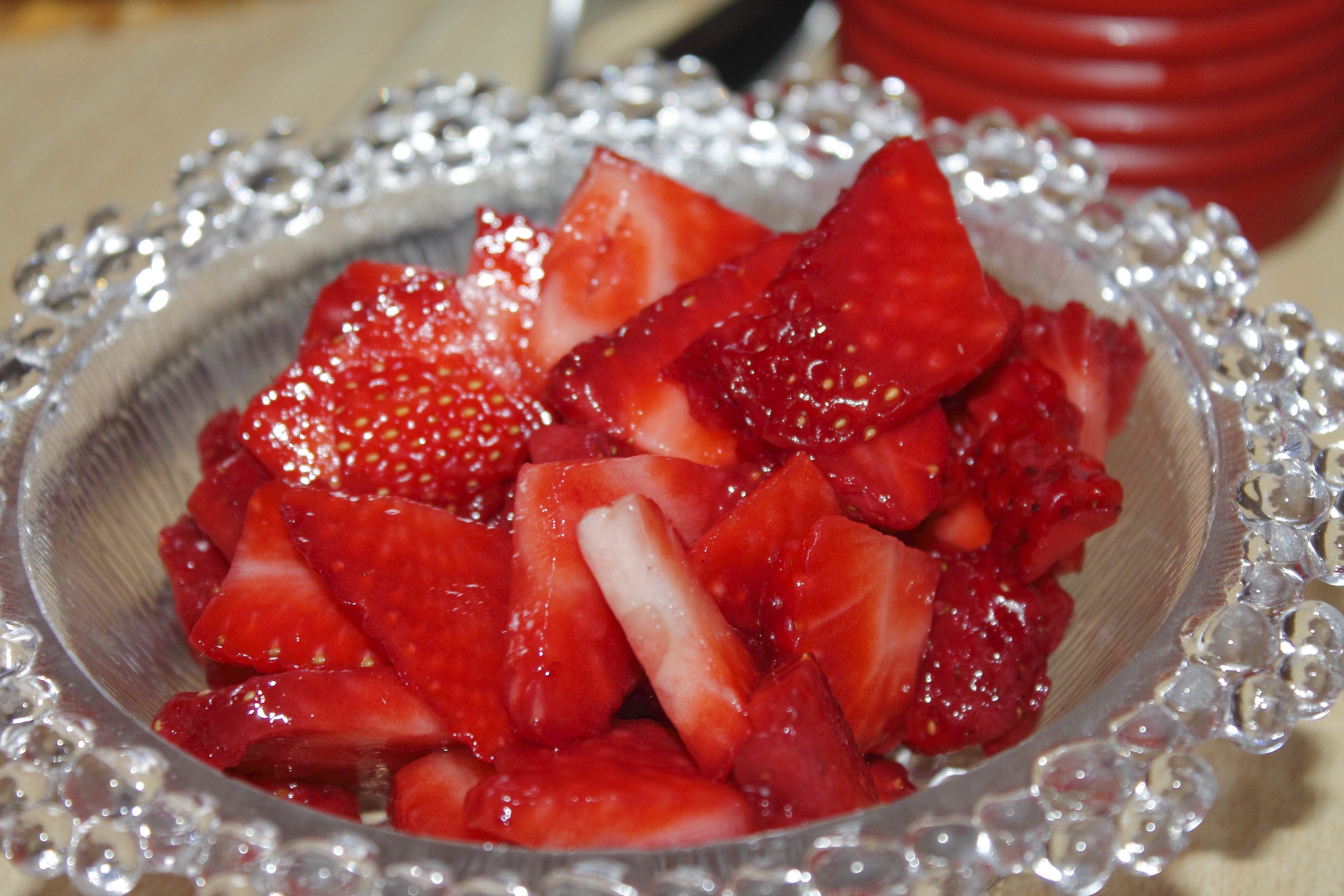 strawberry fruit and clear glass bowl