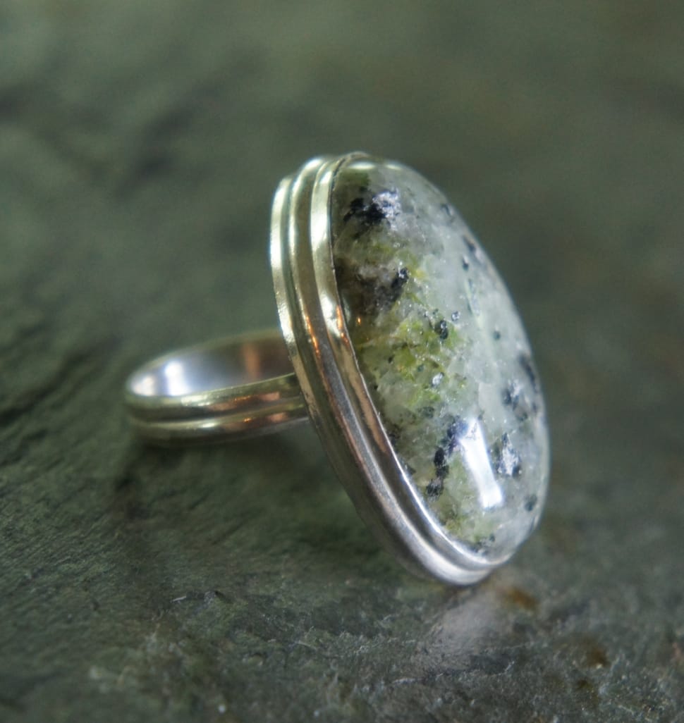 silver cabochon ring on gray marble surface preview