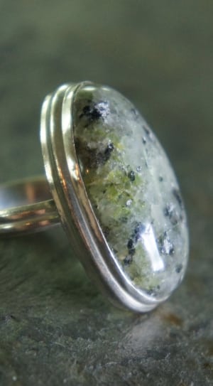 silver cabochon ring on gray marble surface thumbnail