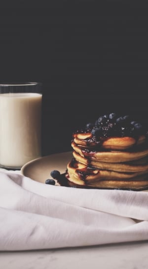 pancakes with blueberry toppings and syrup in white ceramic round plate thumbnail