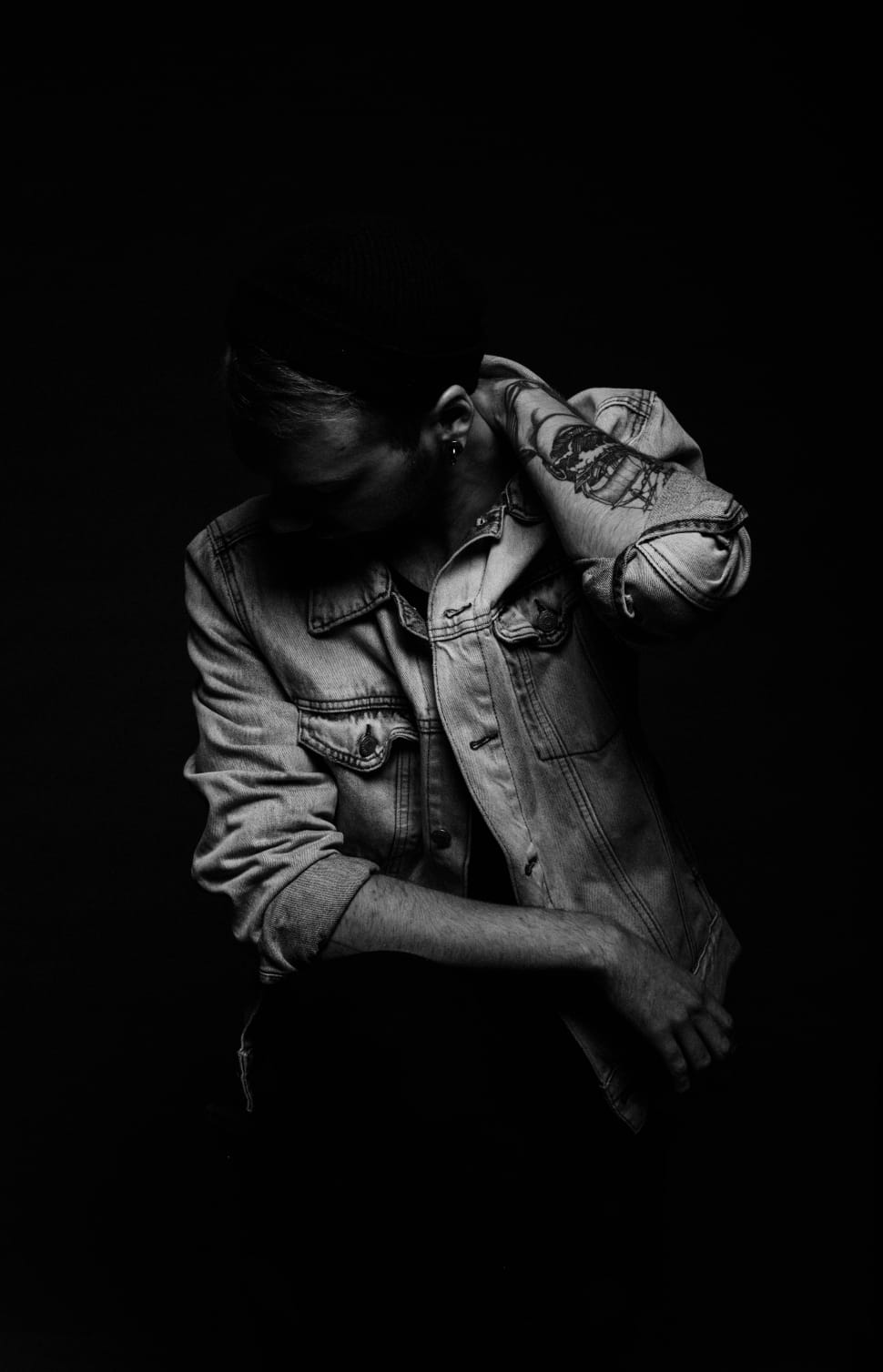 grayscale picture of man wearing denim jacket preview