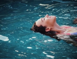 woman with black hair in blue water thumbnail