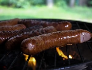 brown sausages on charcoal grill thumbnail