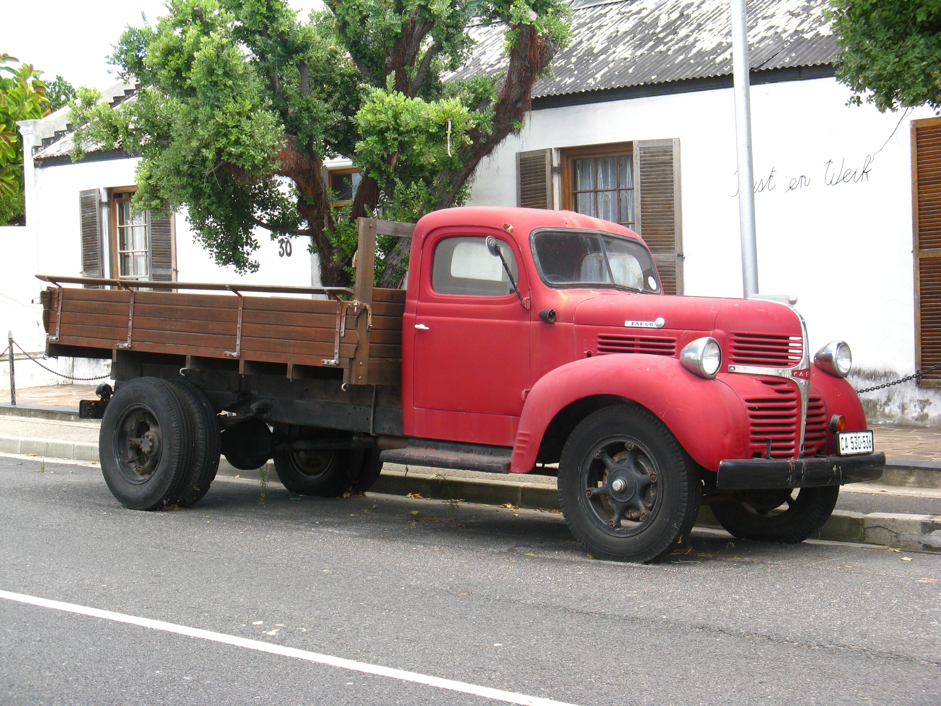 red and brown stake truck