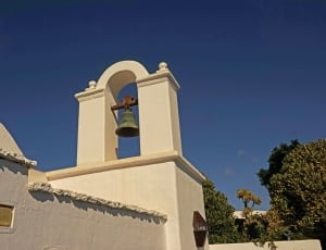 white concrete church with bell thumbnail