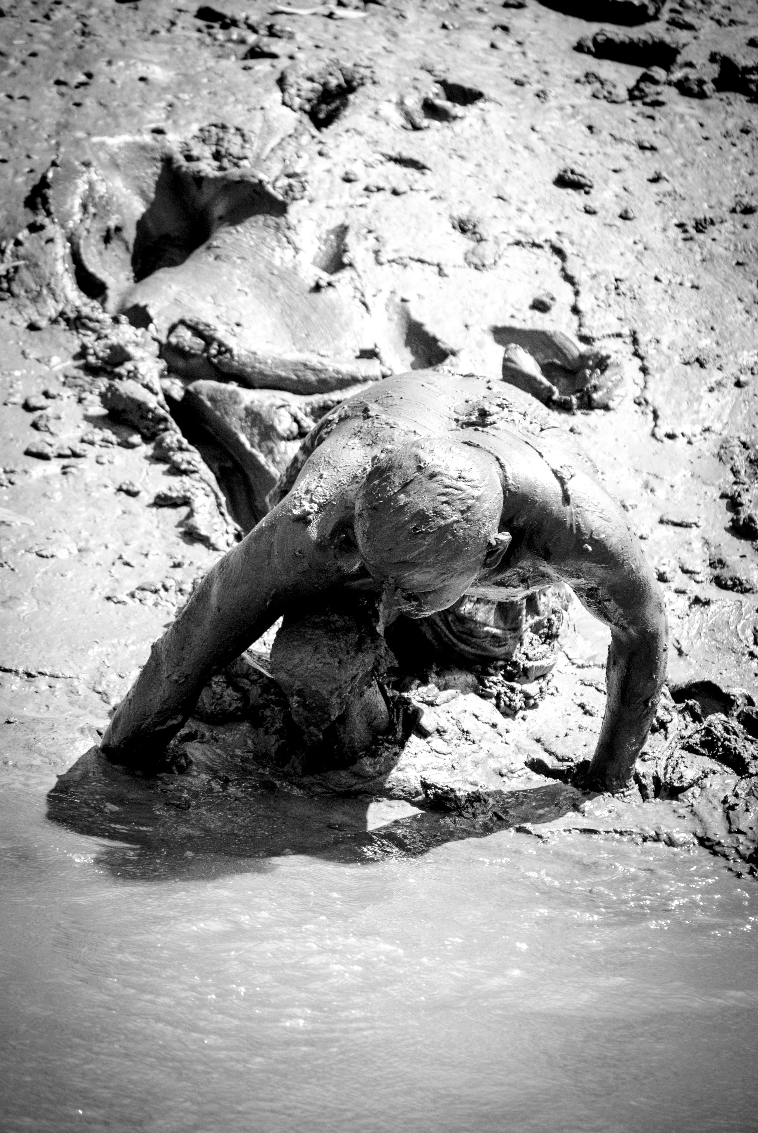 man crawling in mud