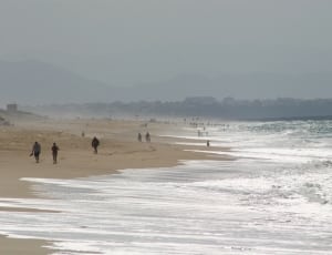 people walking near sea thumbnail