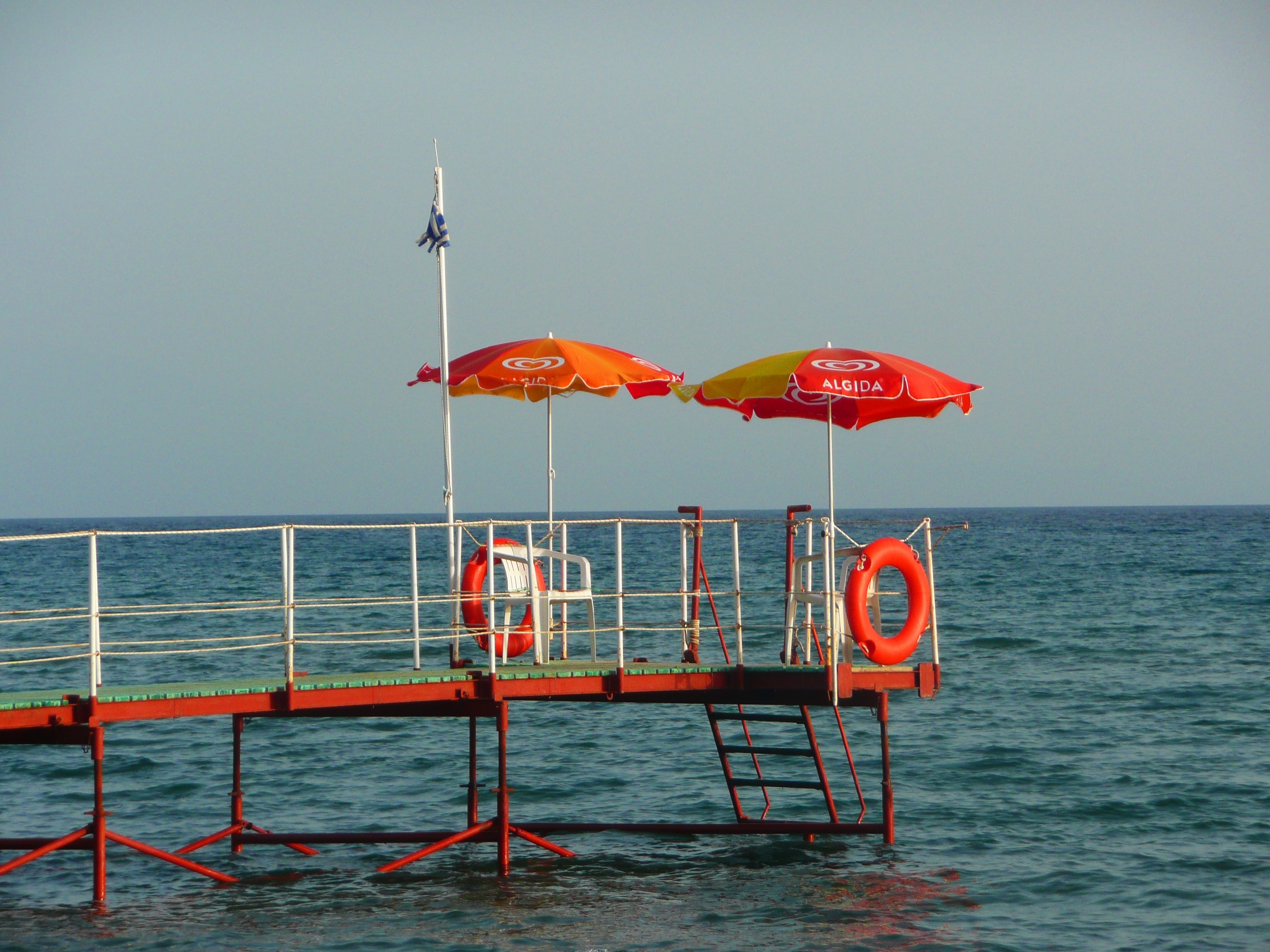 two red-and-yellow parasol umbrella near ocean