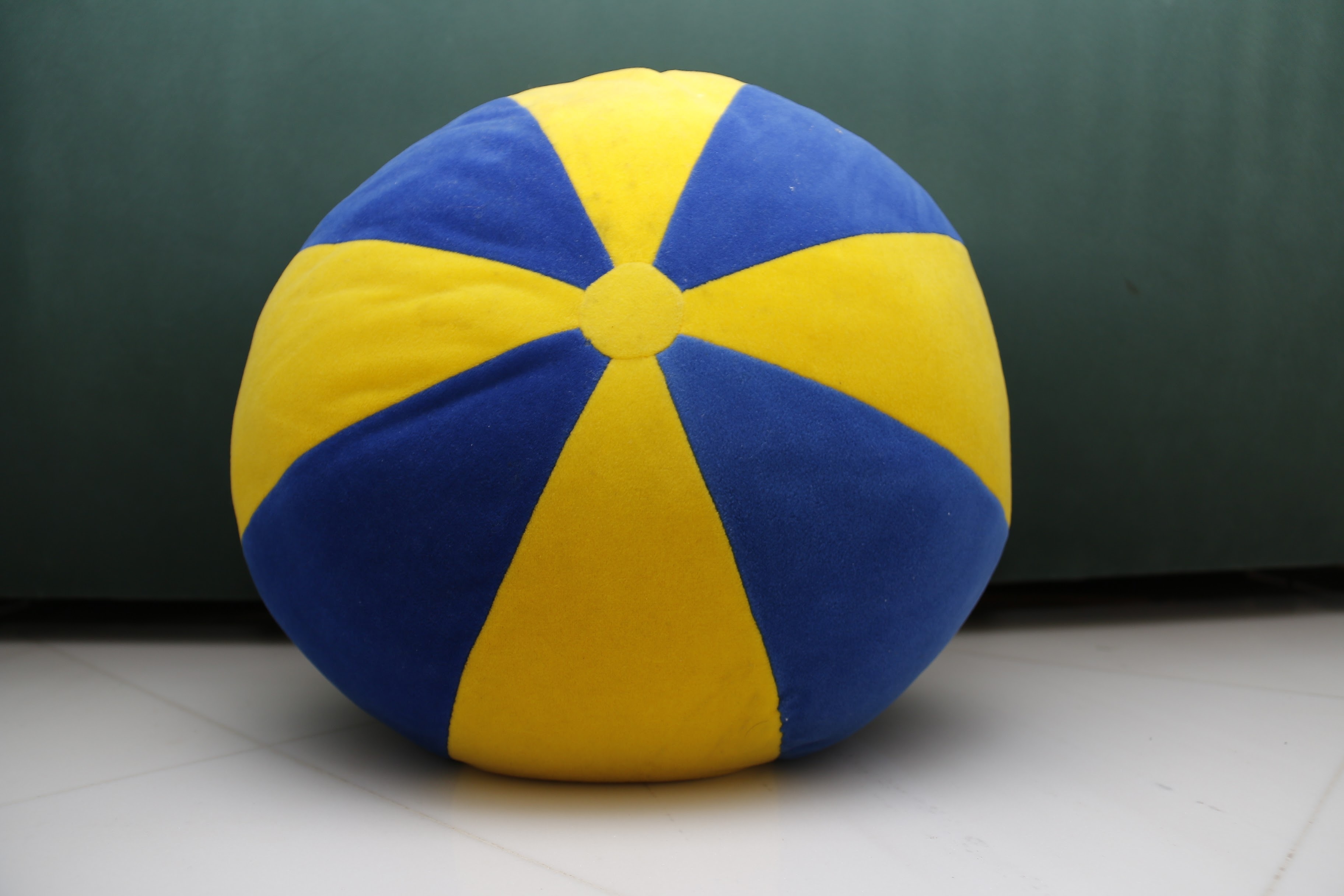 blue and yellow round fabric throw pillow