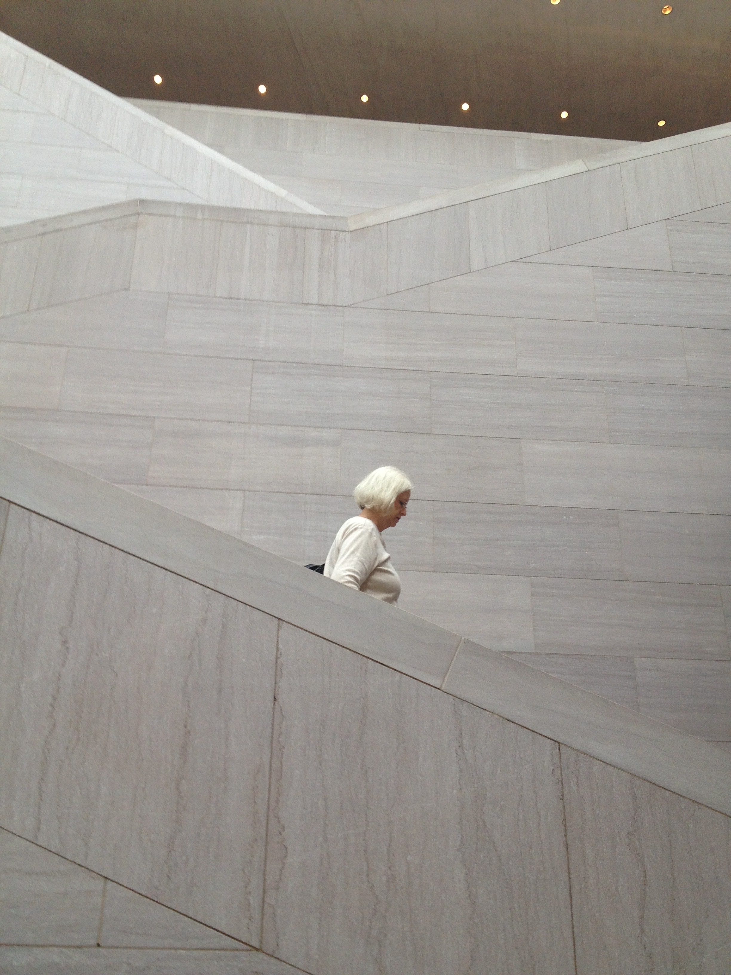 women's white long sleeve shirt walking on stairs