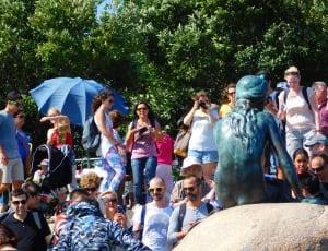 group of people beside the little mermaid statue photo during day time thumbnail