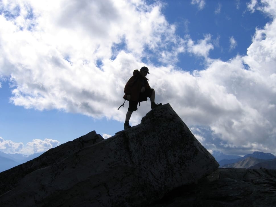 silhouette photo of man in top of mountain preview