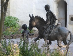 person riding horse infront of child monument thumbnail