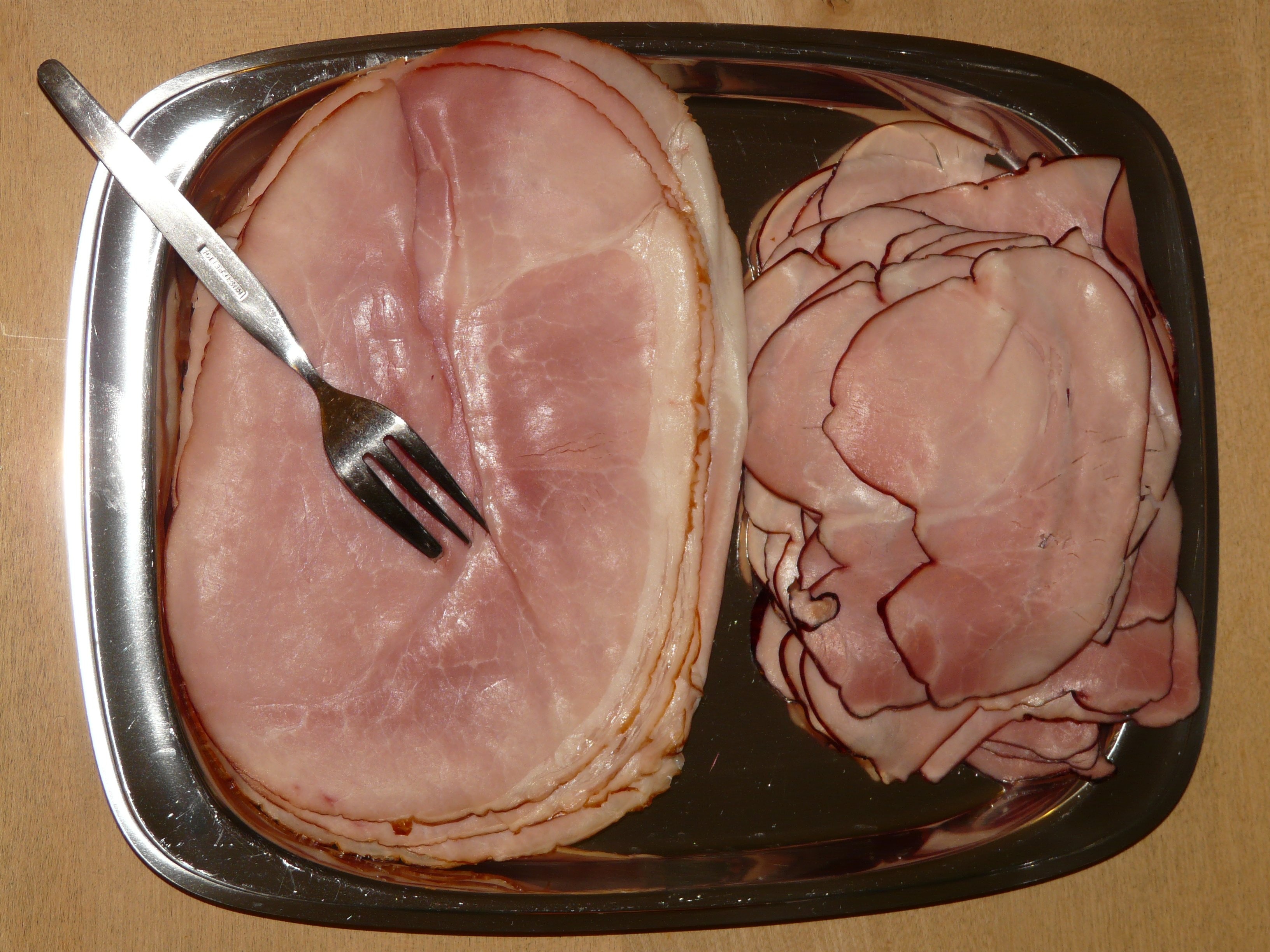 raw ham and stainless steel fork
