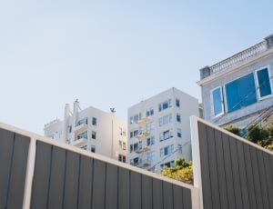low angle photography of two white buildings thumbnail