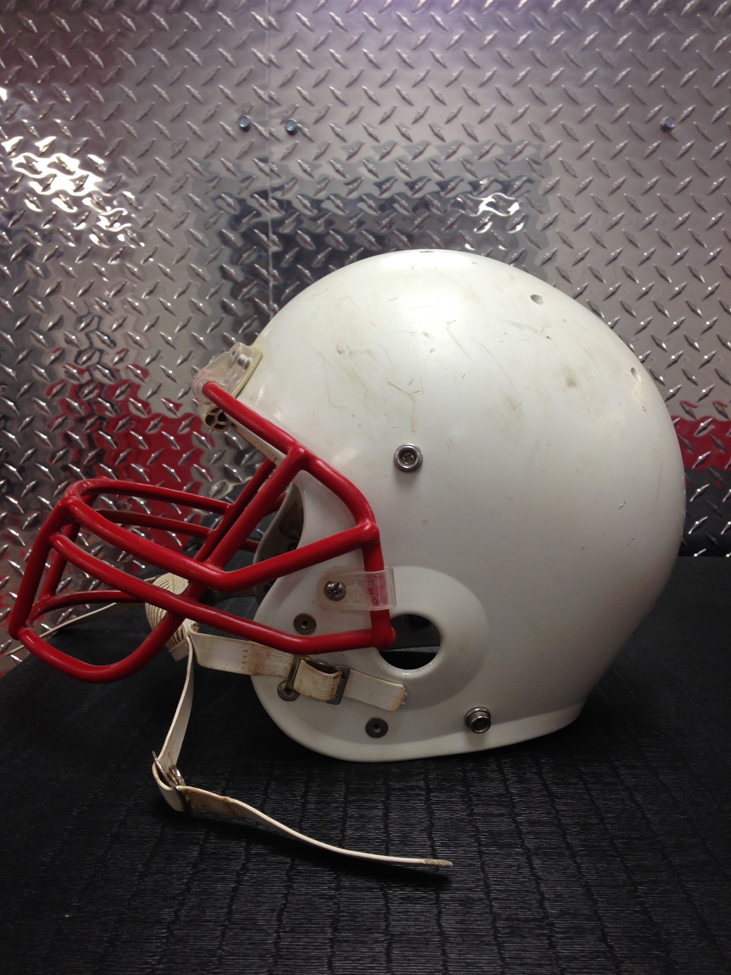 white and red american football helmet