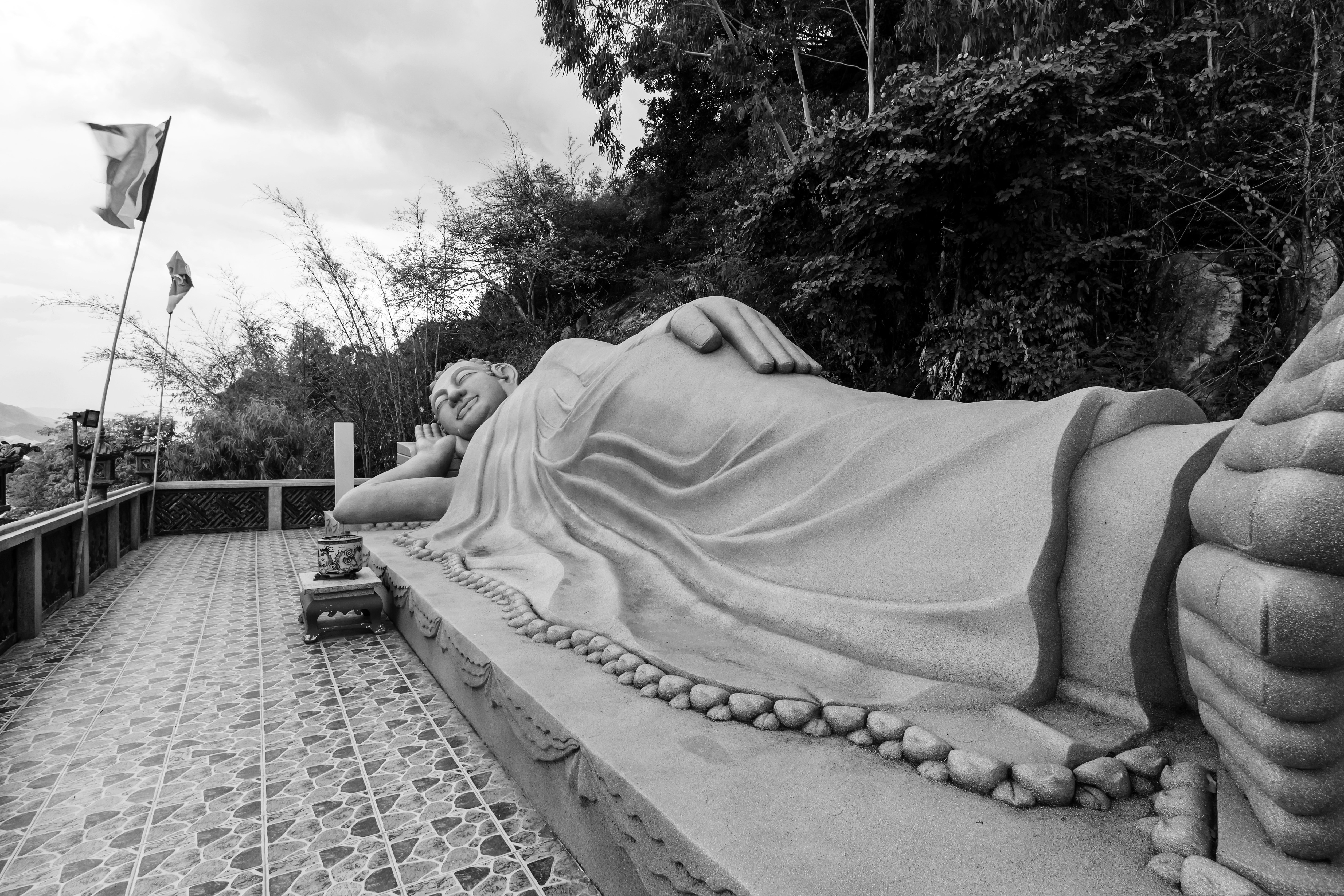 grayscale photo of reclining buddha