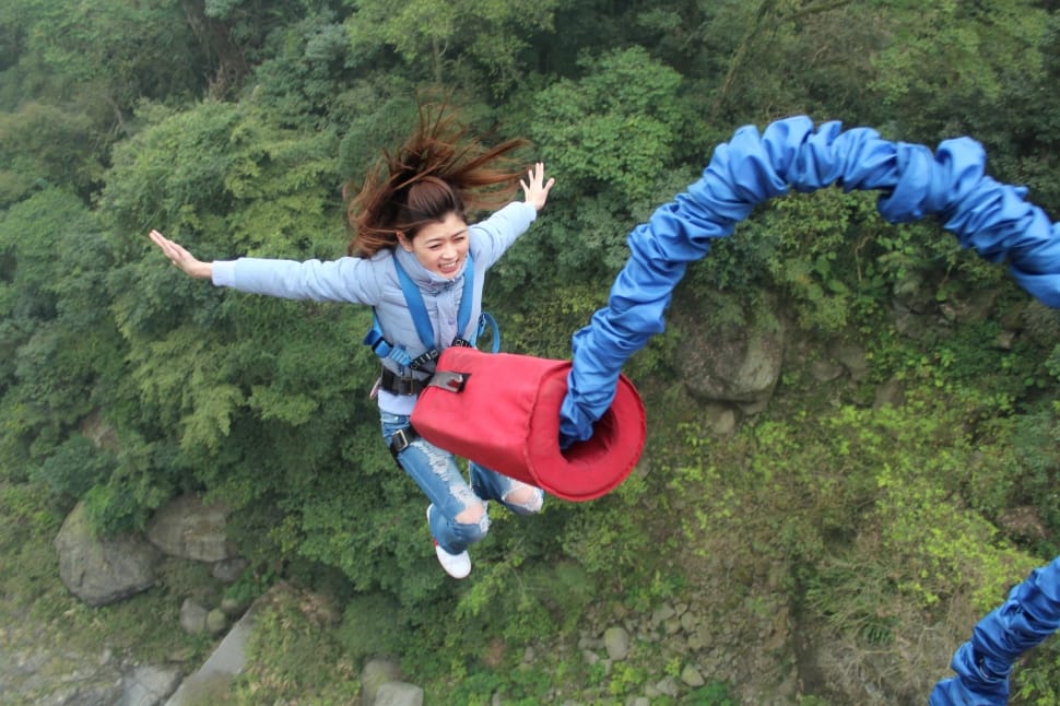 woman jumping with red and blue harness preview