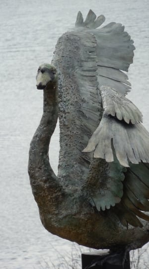 green and gray bird statue thumbnail