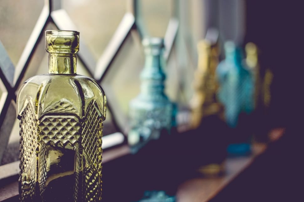 closeup photography of yellow tinted glass bottle preview