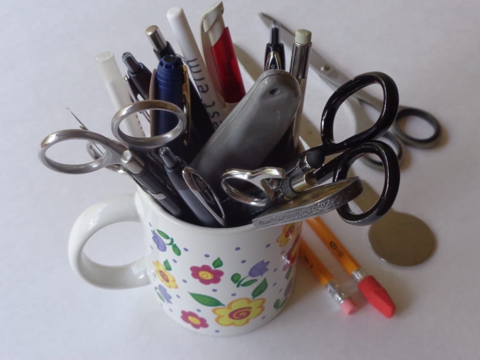 scissors, pens and pencils on ceramic mug preview