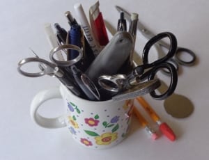 scissors, pens and pencils on ceramic mug thumbnail