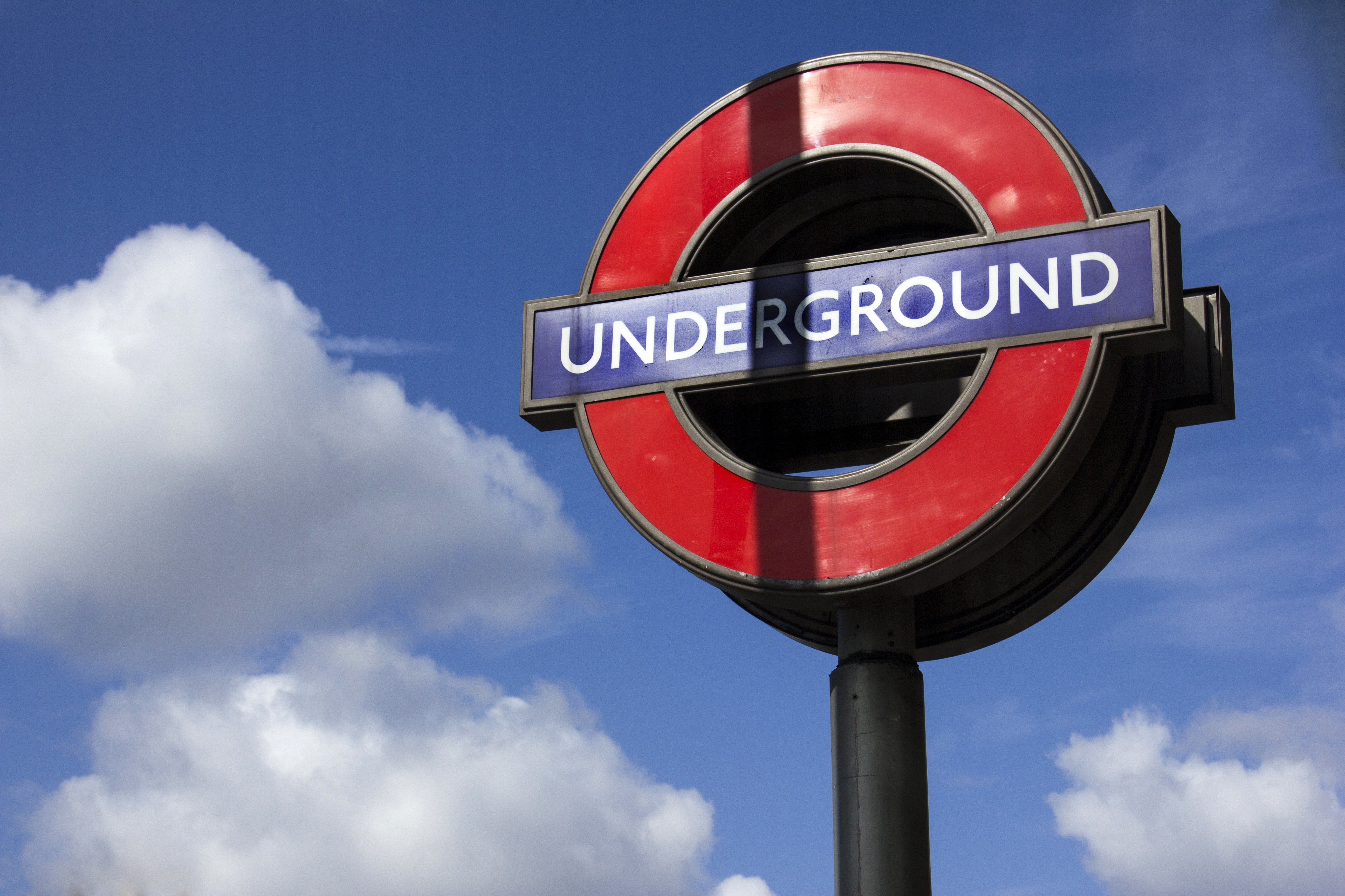 red black and blue underground round signage