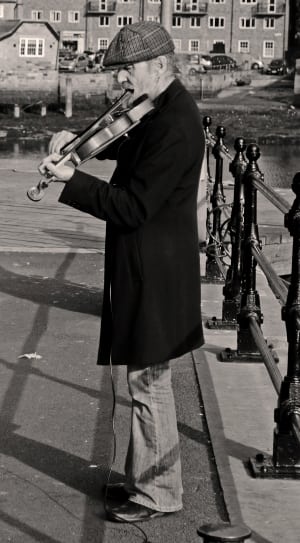 grayscale photography of man playing violin thumbnail