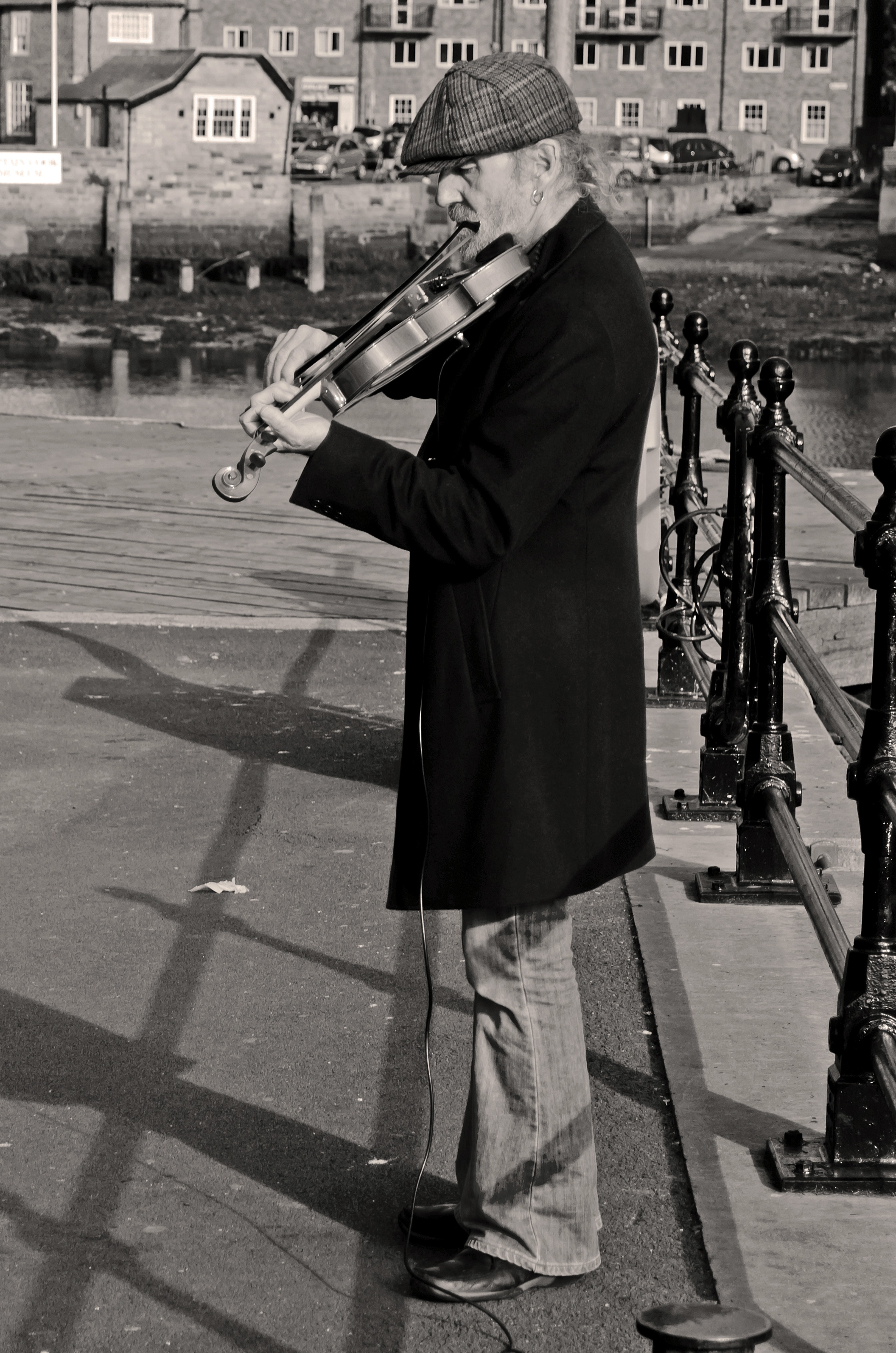 grayscale photography of man playing violin