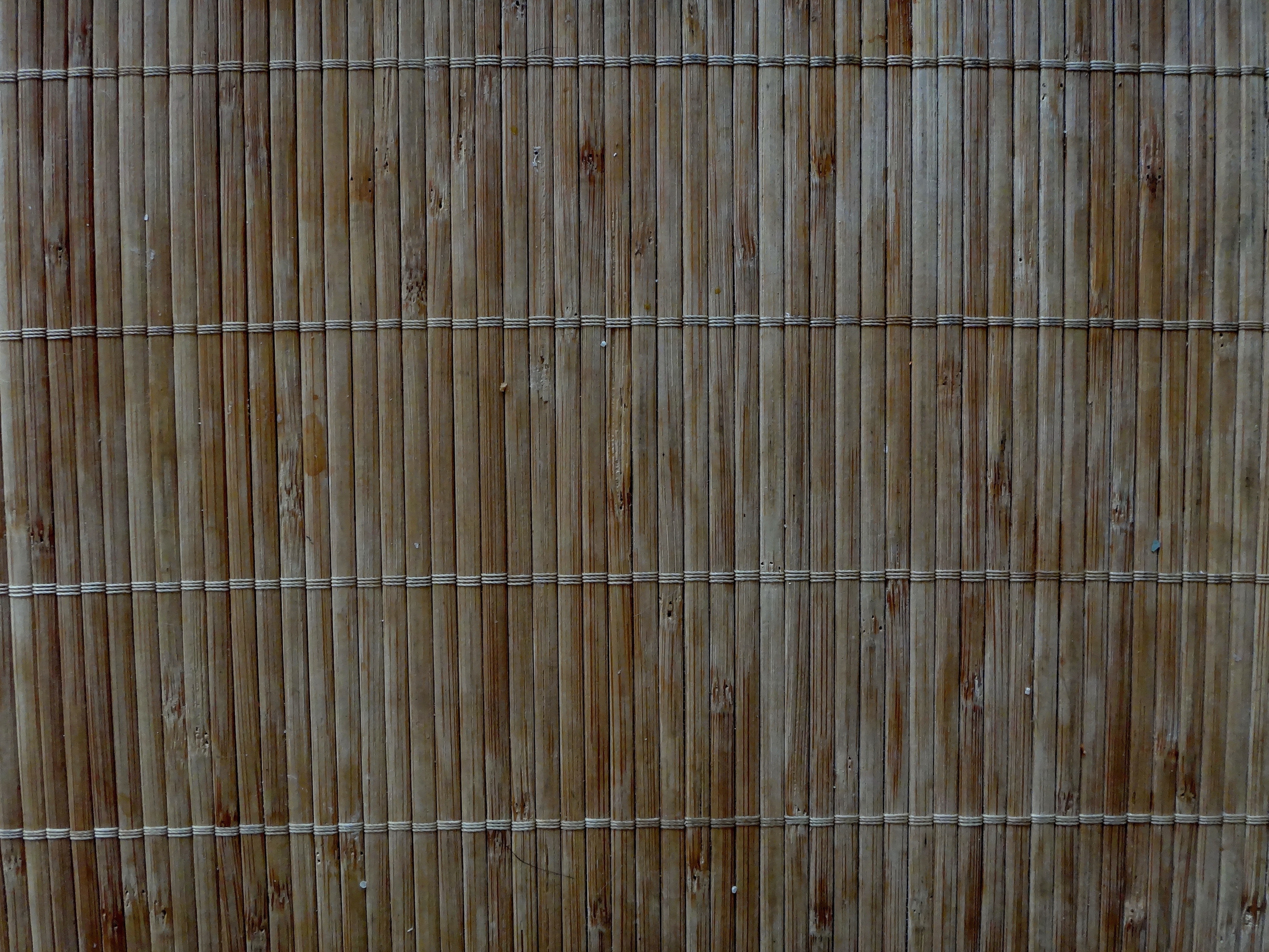 brown and beige wooden bamboo fence