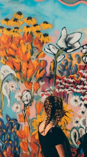 woman looking at a floral wall artwork thumbnail