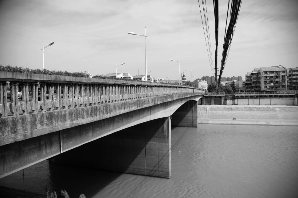 greyscale photo of bridge during daytime preview