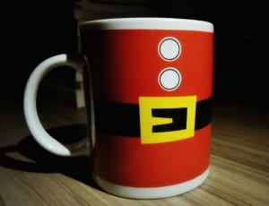 yellow black and red ceramic mug thumbnail
