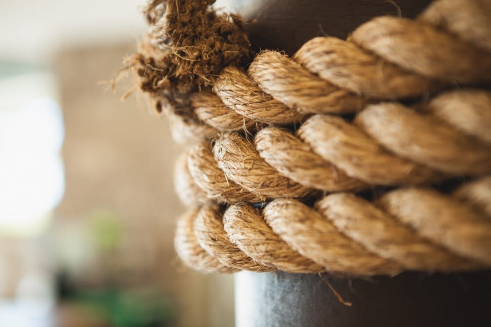 brown rope tied in pole on selective focus photography preview