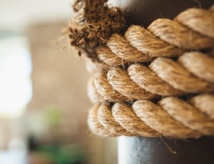 brown rope tied in pole on selective focus photography thumbnail