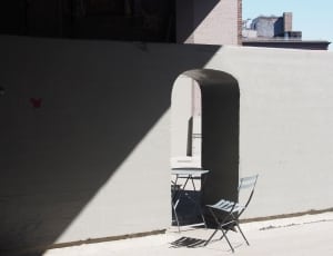 shallow focus photography of grey chair in front table during daytime thumbnail