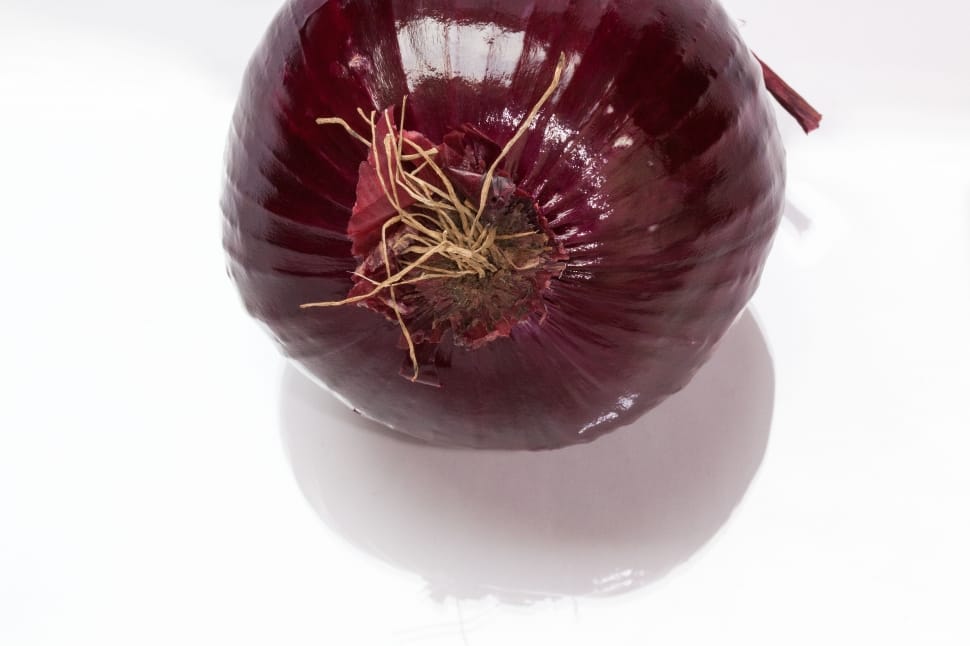 red onion on white table preview