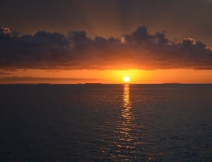 photography of sunset in sea thumbnail