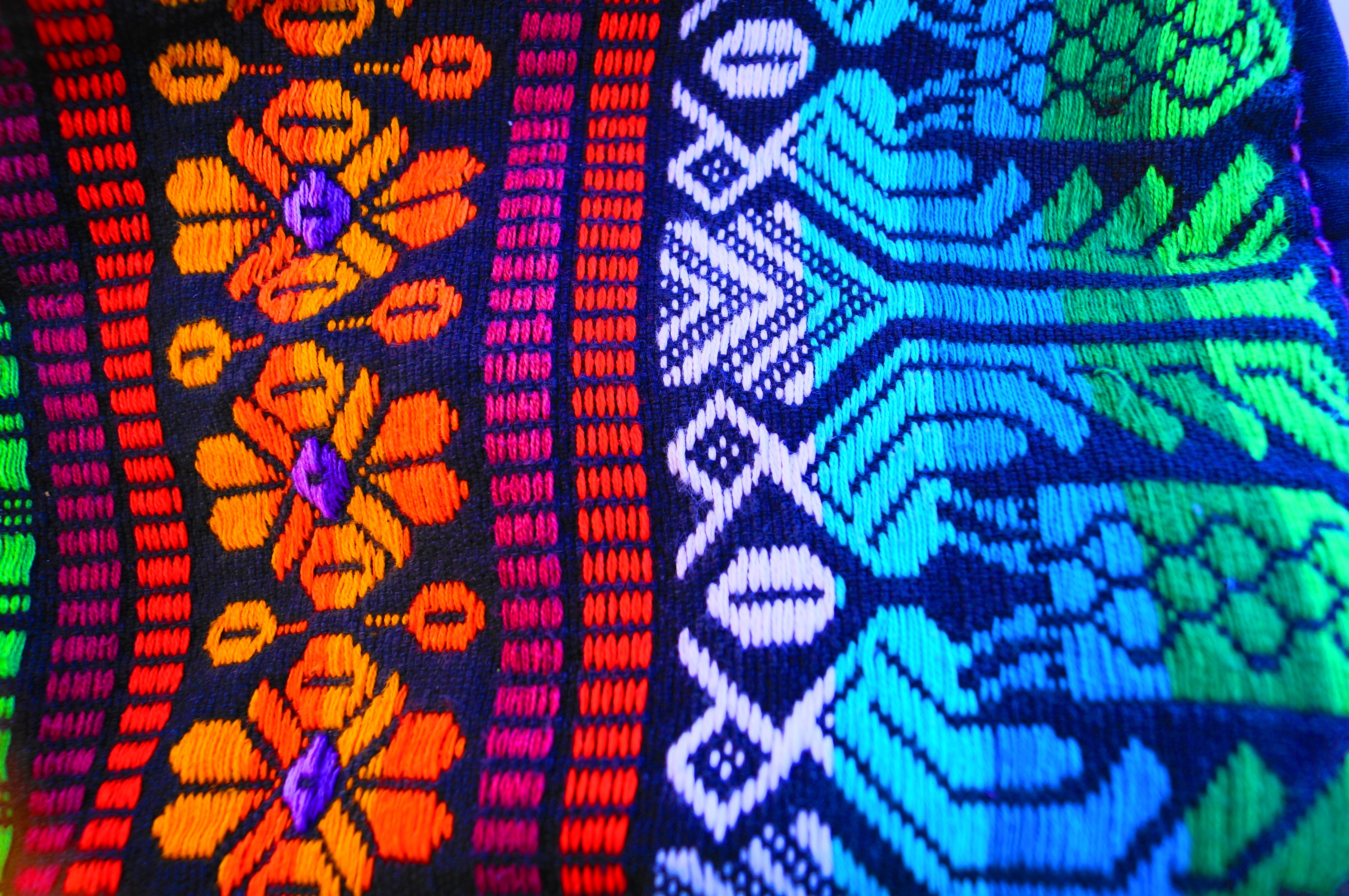 teal green blue red and orange textile