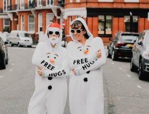 two person wearing white overalls thumbnail