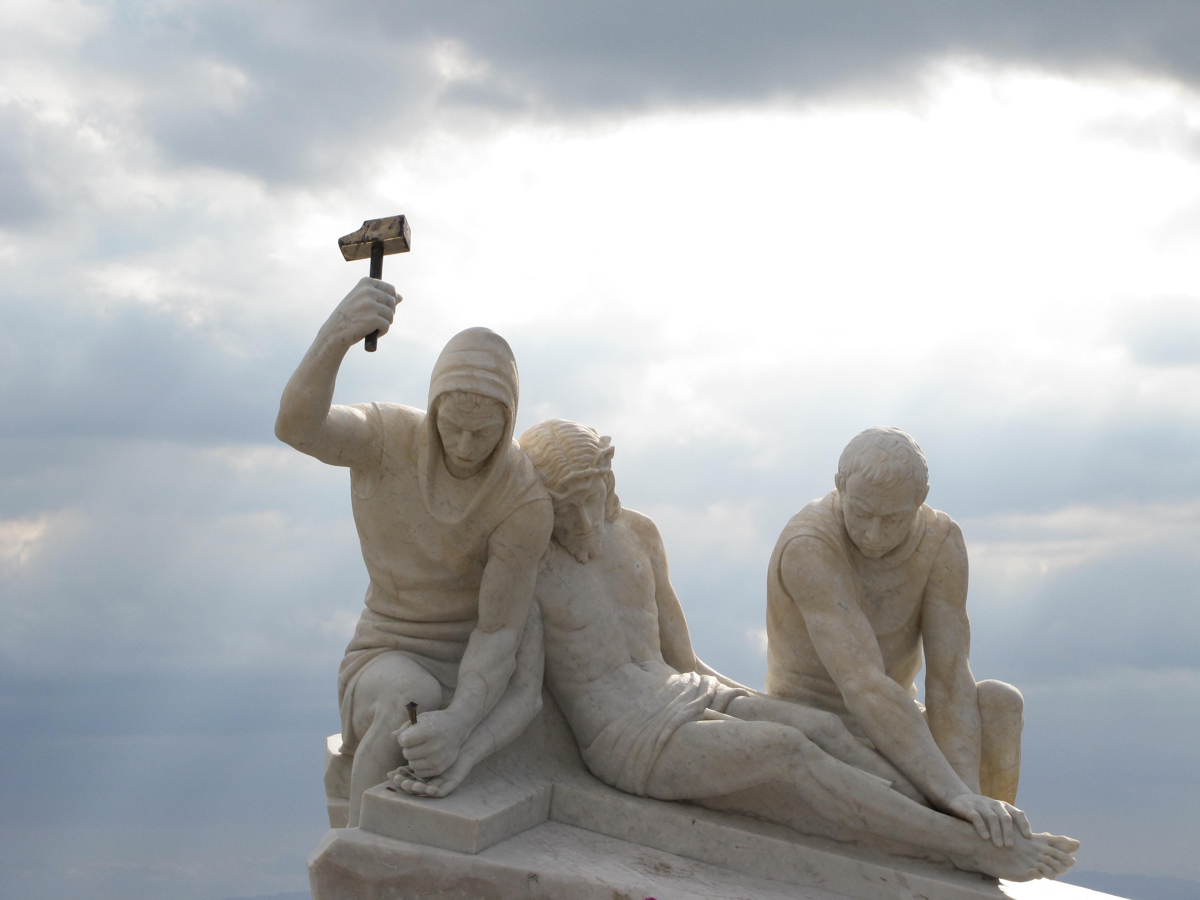 crucifying jesus statue