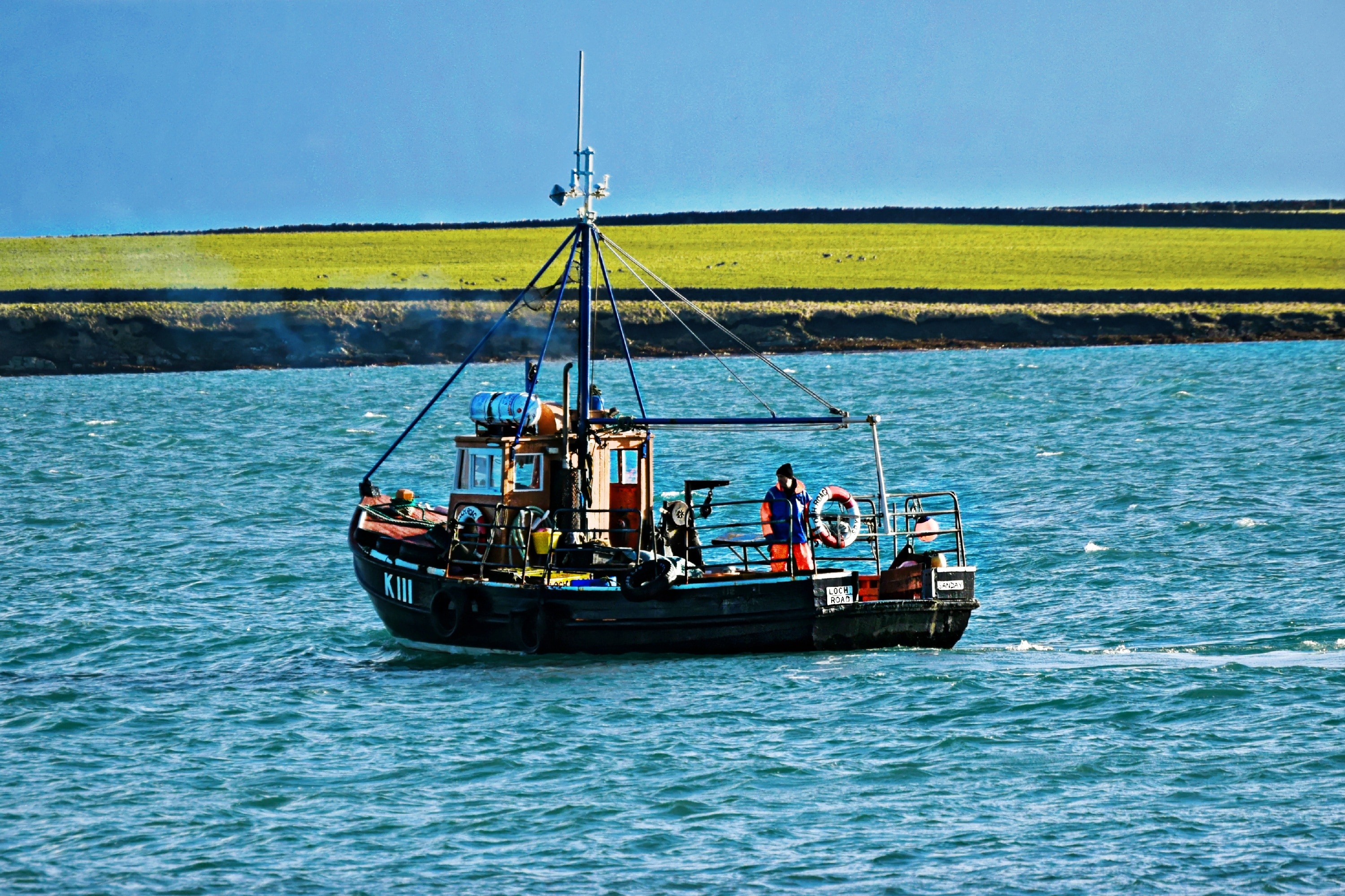 photography of person ride on boat on body of water