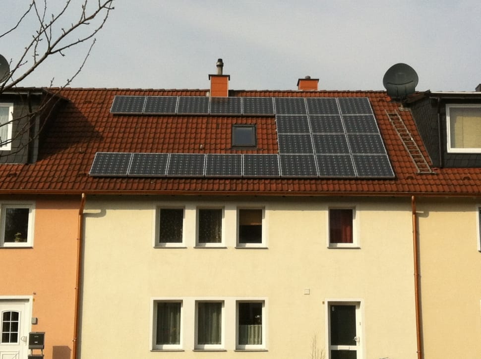 white and brown house with black panel solar preview