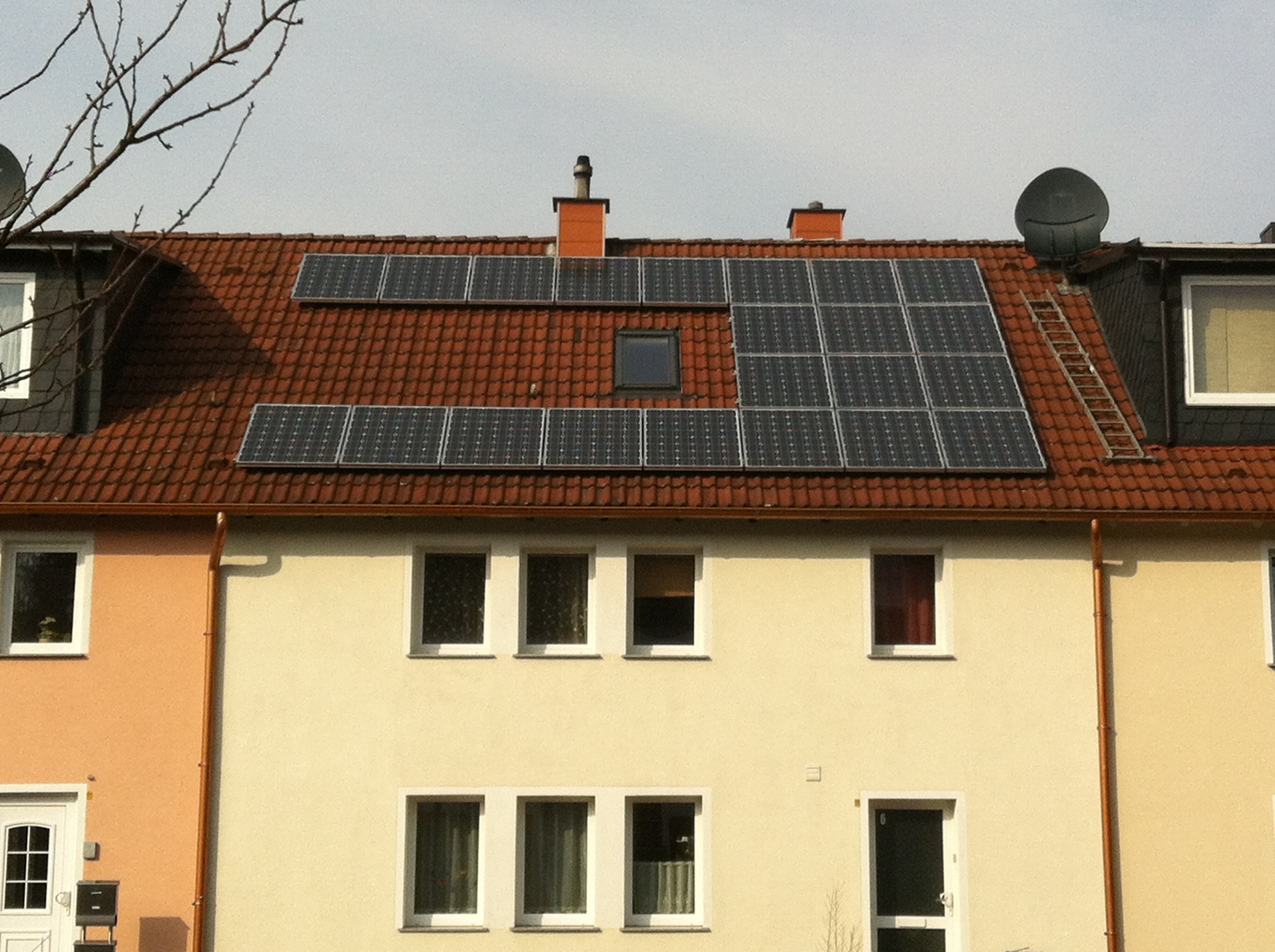 white and brown house with black panel solar