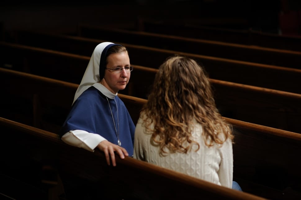 woman in white long sleeve shirt talking to a nun preview