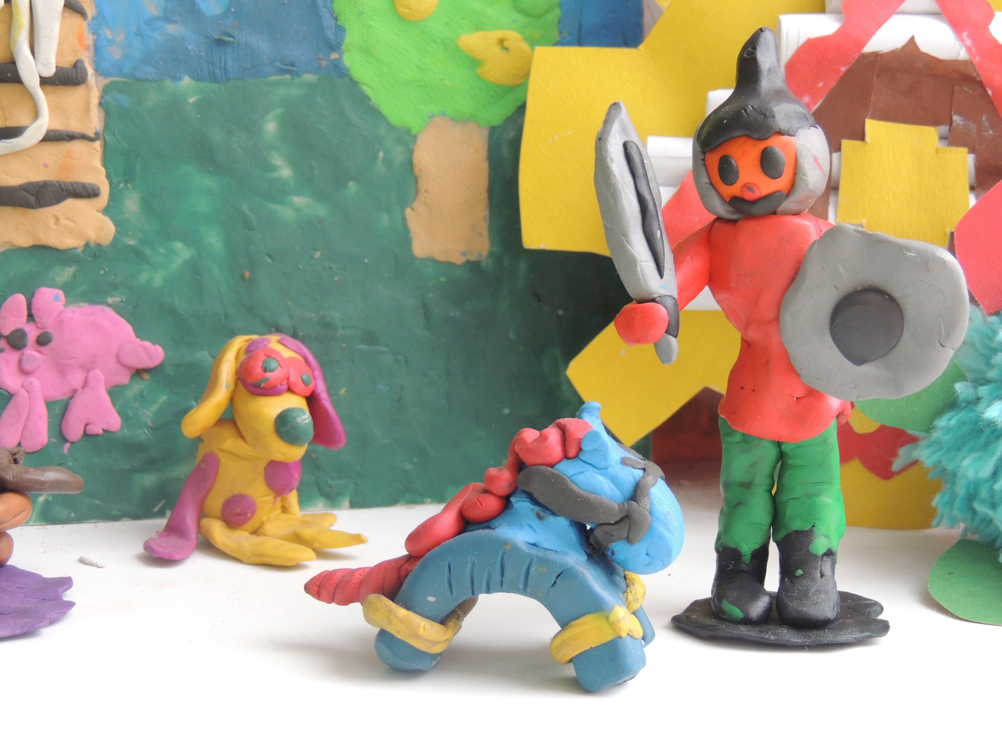 dog, horse and man holding sword and shield clay figurines