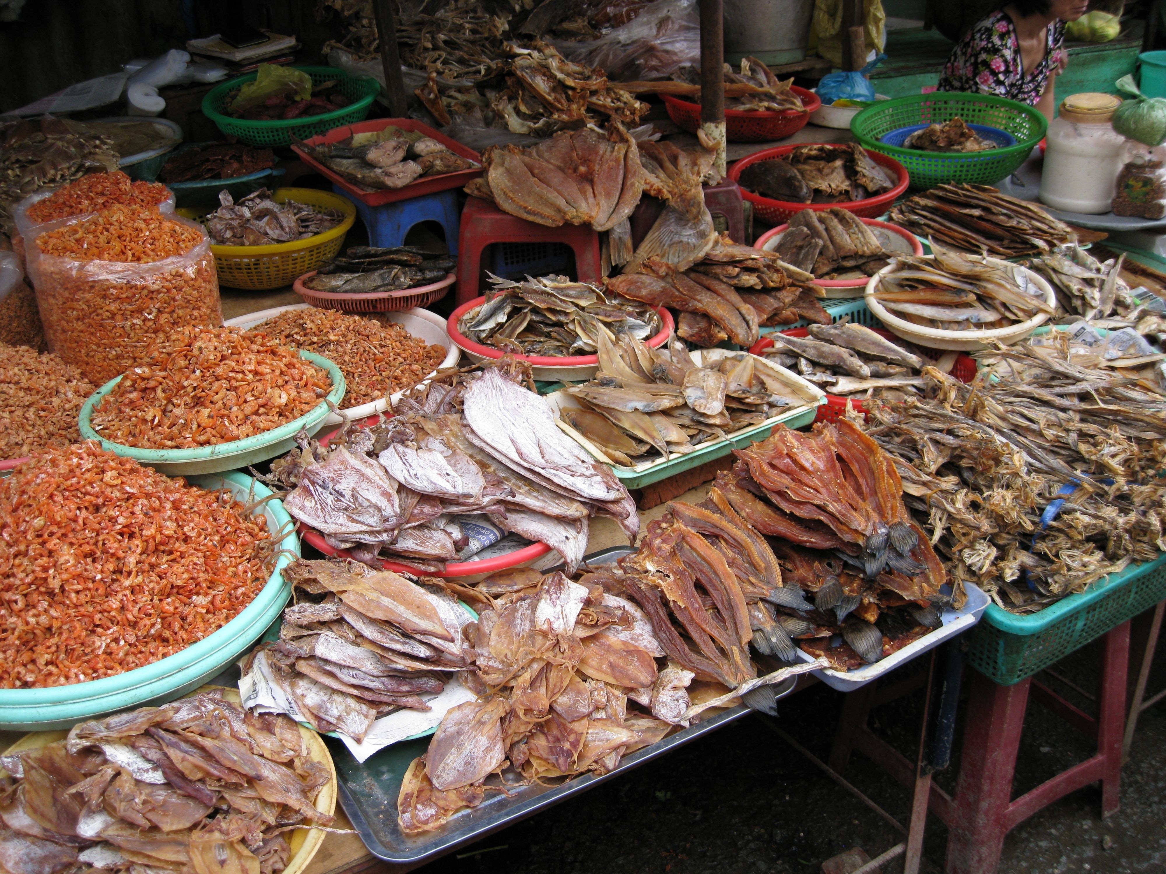 assorted dried fishes on plastic containers