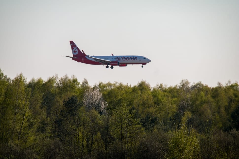red and white Airberlin plane flying during daytime preview
