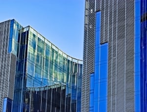 blue and gray curtain wall and steel high rise building thumbnail