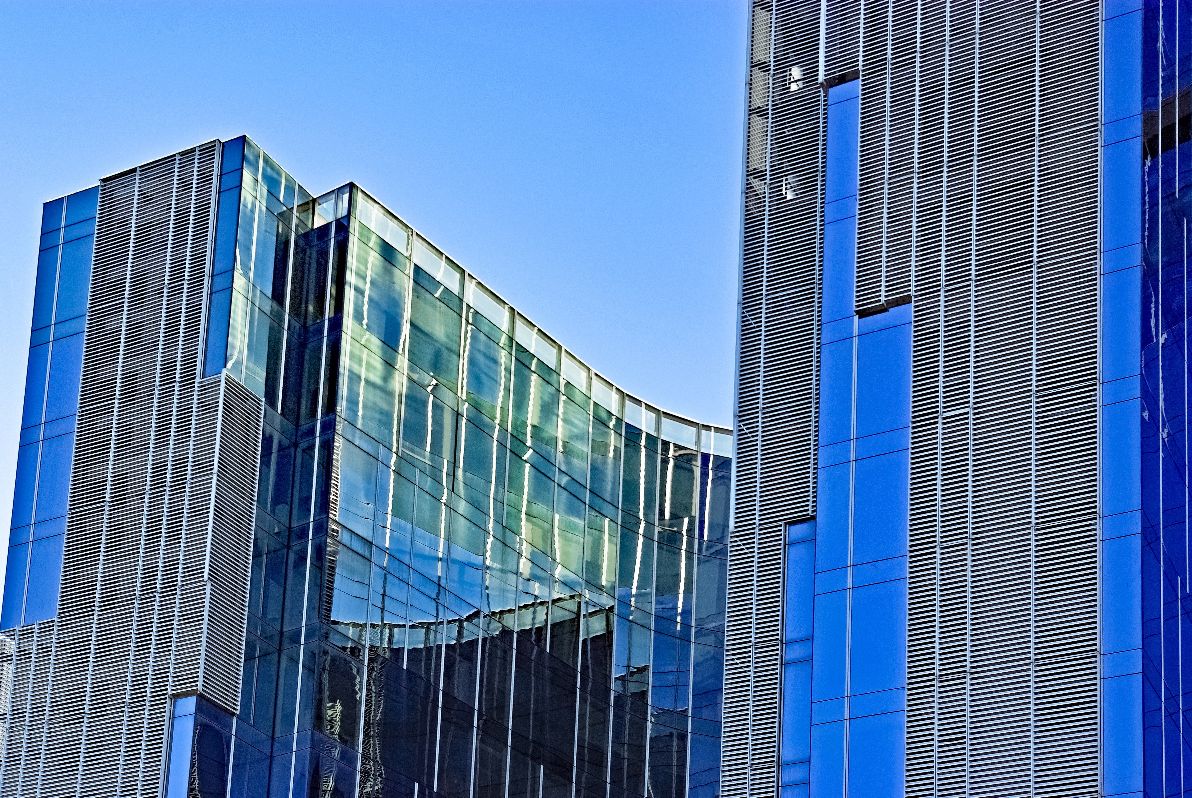 blue and gray curtain wall and steel high rise building